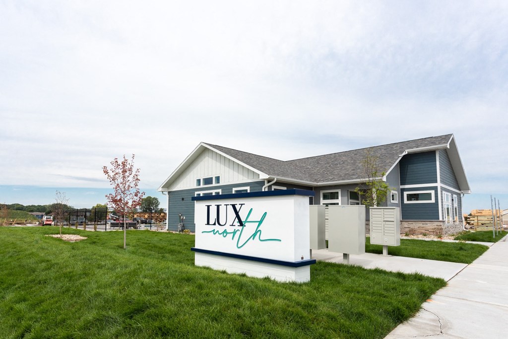 a house with a sign in front of it that reads lux capital