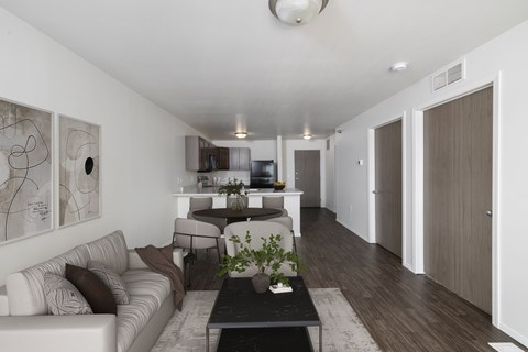 A modern living room with a white couch and a coffee table.