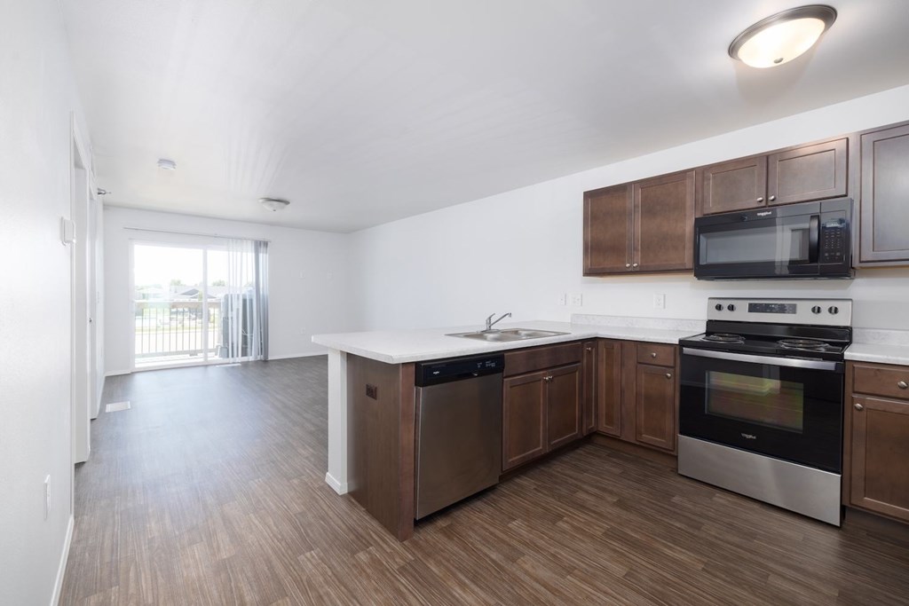 A kitchen with wooden cabinets and stainless steel appliances.