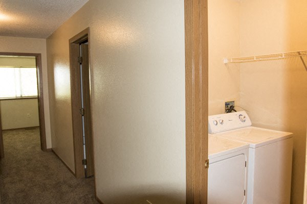 a laundry room with a washer and dryer and a closet