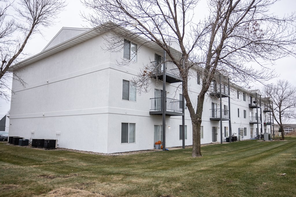 a white building with trees in front of it