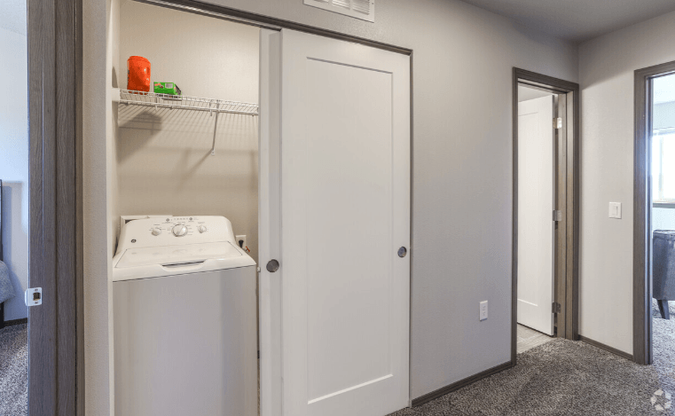 a laundry room with a washer and dryer and a closet