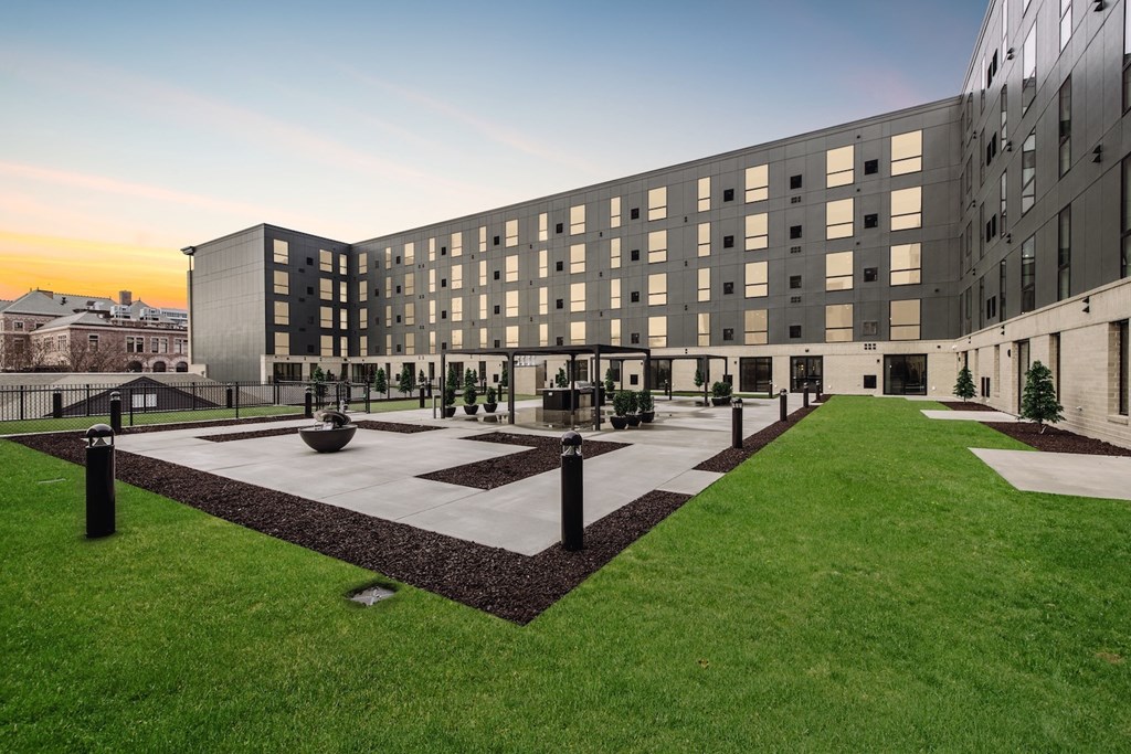 A modern building with a courtyard in front.