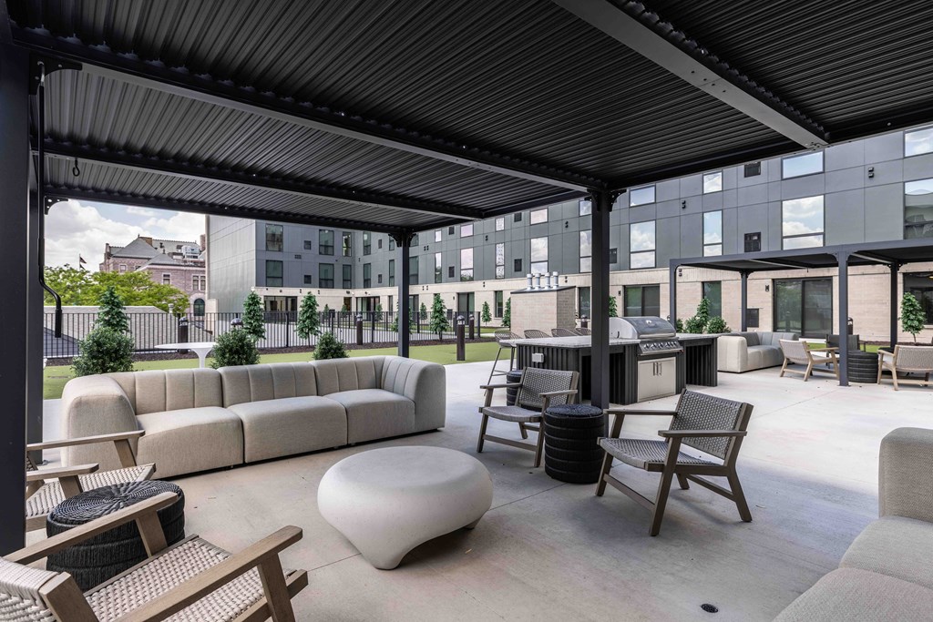 A patio with a white bean bag and wooden chairs.