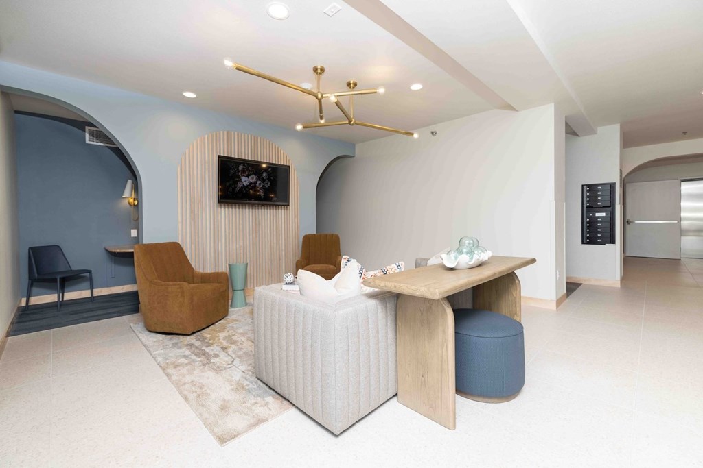 A modern living room with a white sofa and a wooden coffee table.