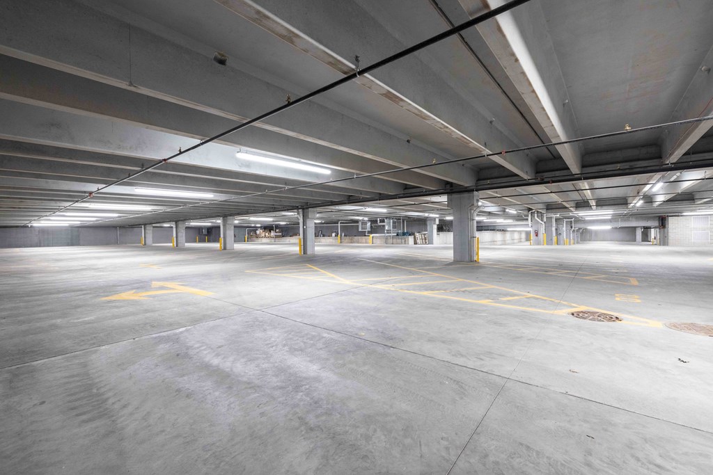 A large, empty parking garage with concrete floors and ceilings.