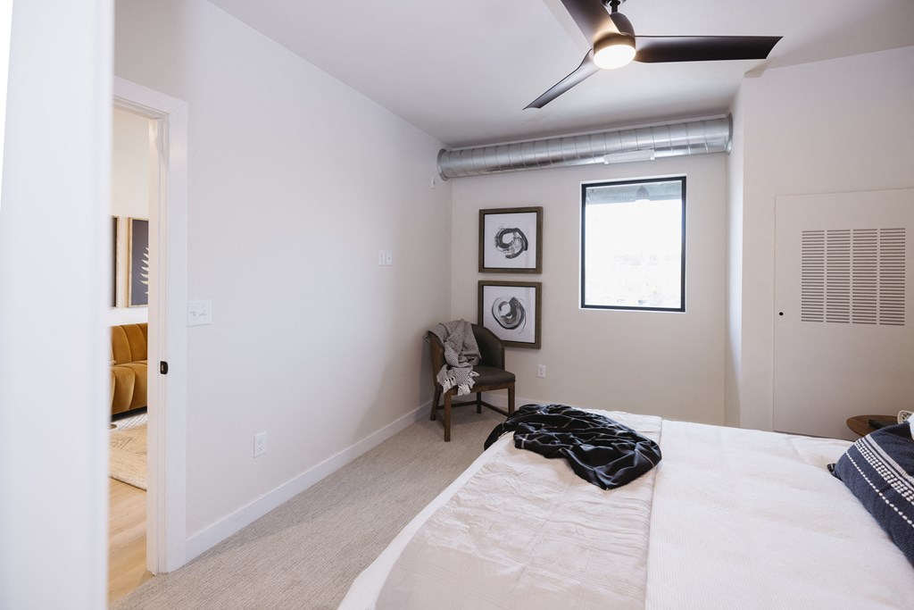 a bedroom with a large white bed and a window