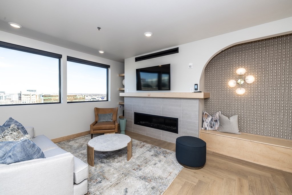 A modern living room with a fireplace and a flat screen TV.