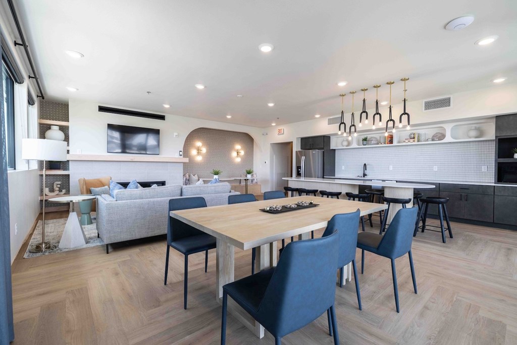 A modern kitchen with a dining table and chairs.