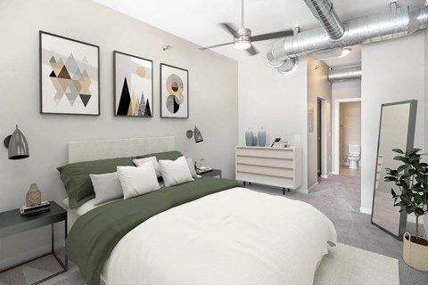 a bedroom with a large bed and paintings on the wall