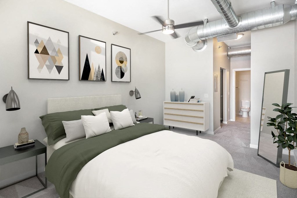 a bedroom with a large bed and paintings on the wall