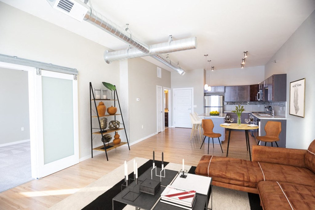 a living room with a couch and a table and a kitchen