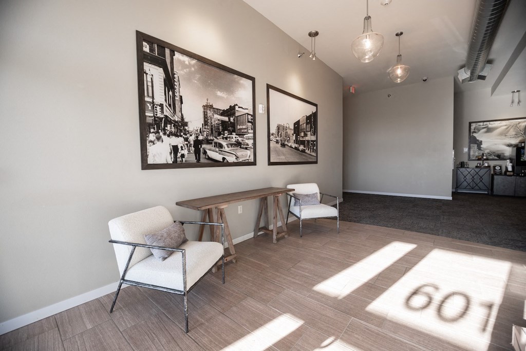 a room with chairs and a table and pictures on the wall