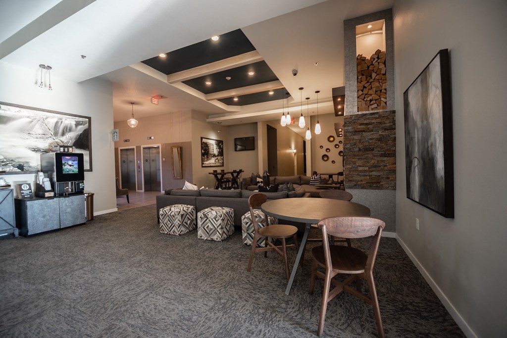 a living room with a couch table and chairs and a tv