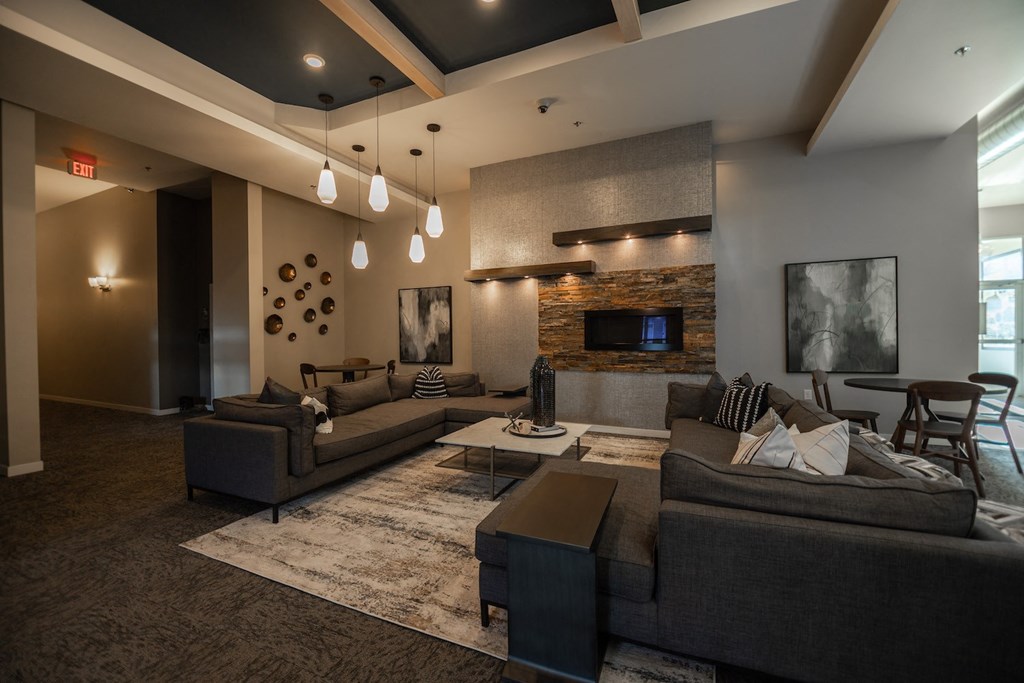 a large living room with couches and a fireplace