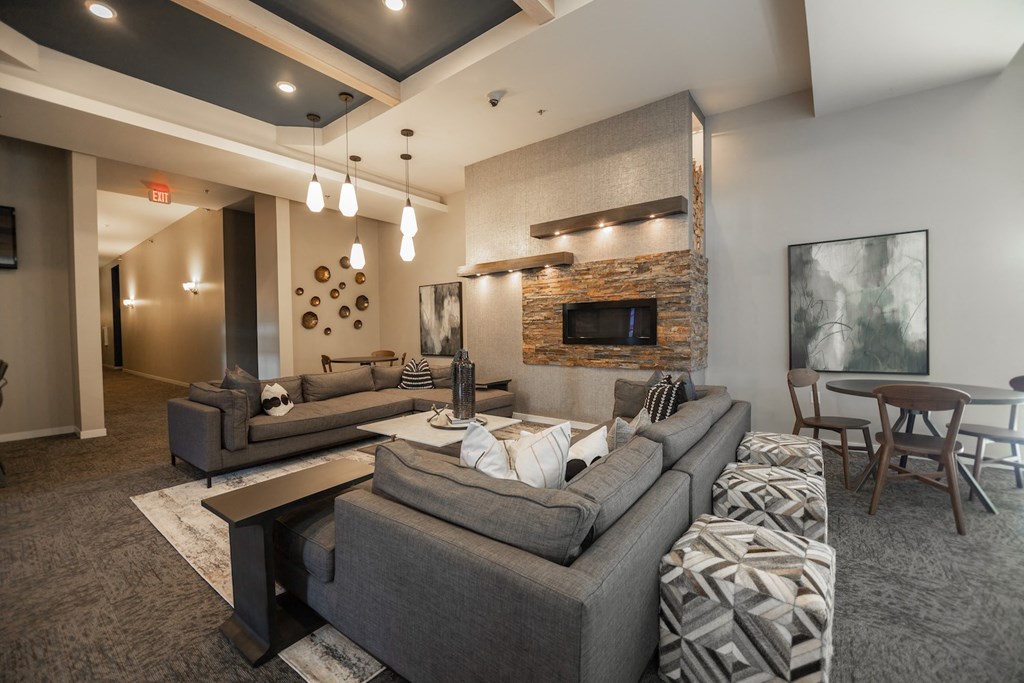 a living room with couches and chairs and a fireplace