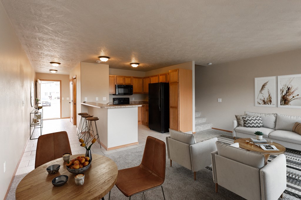 a living room and kitchen with a dining table and chairs