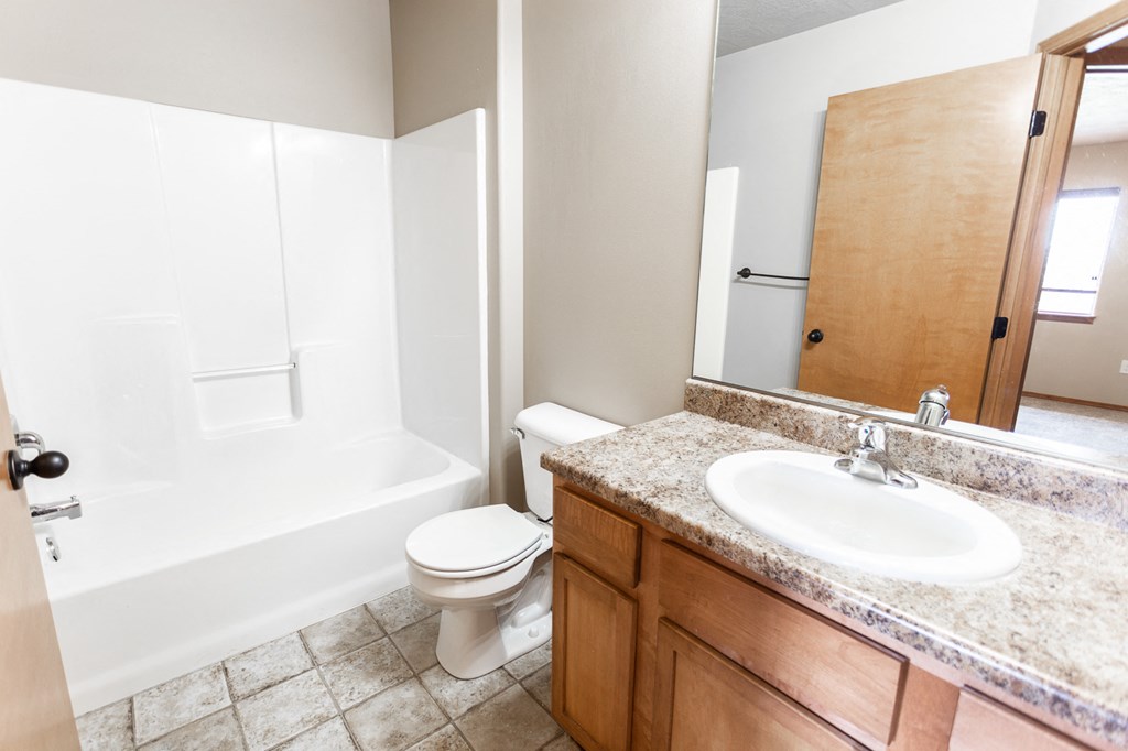an empty bathroom with a toilet and a sink