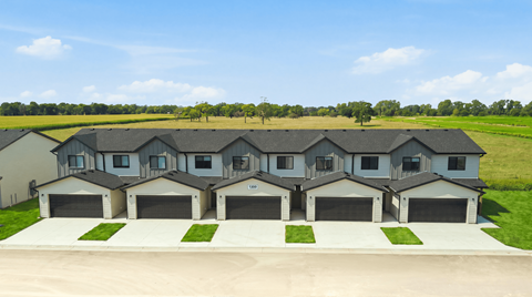 A row of houses with garages in front.
