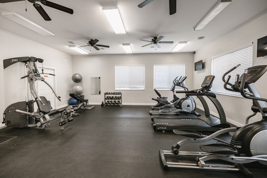 a gym with treadmills and other exercise equipment