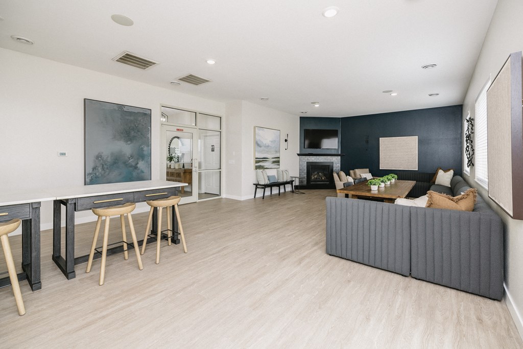 a living room with a couch and a bar and a dining room