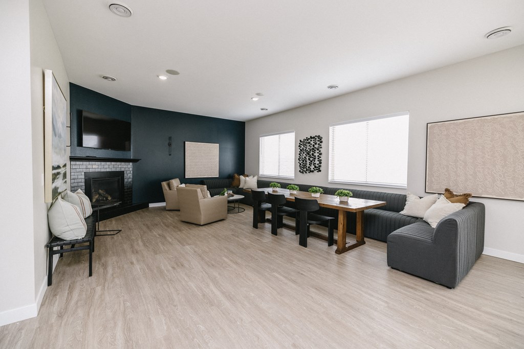 a living room with a fireplace and a table and chairs