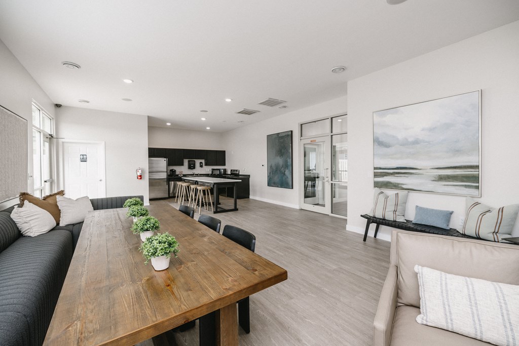 a living room and dining room with a wooden table