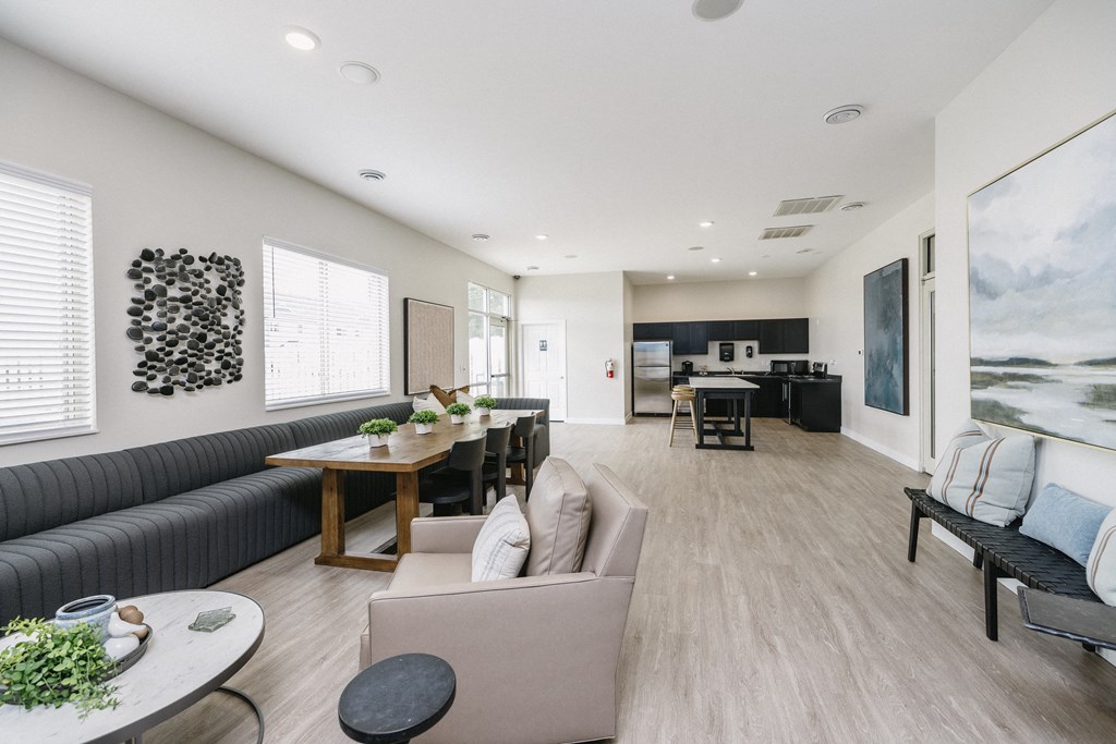a living room and dining room with couches and a table