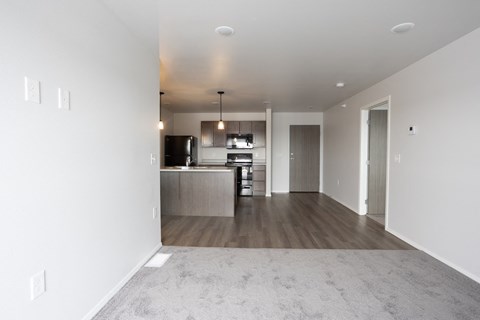 an empty living room and kitchen in a new home