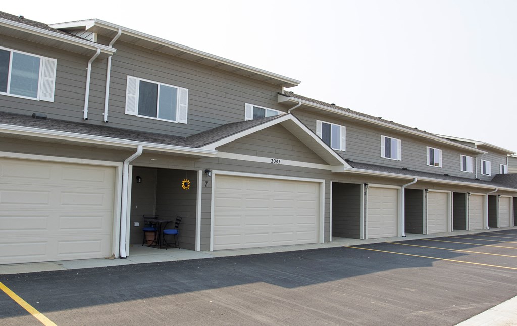 the front of a house with white garage doors