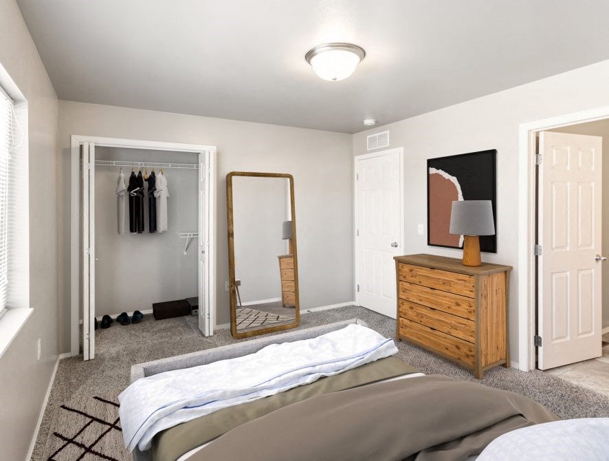 a bedroom with a bed and closet and a mirror