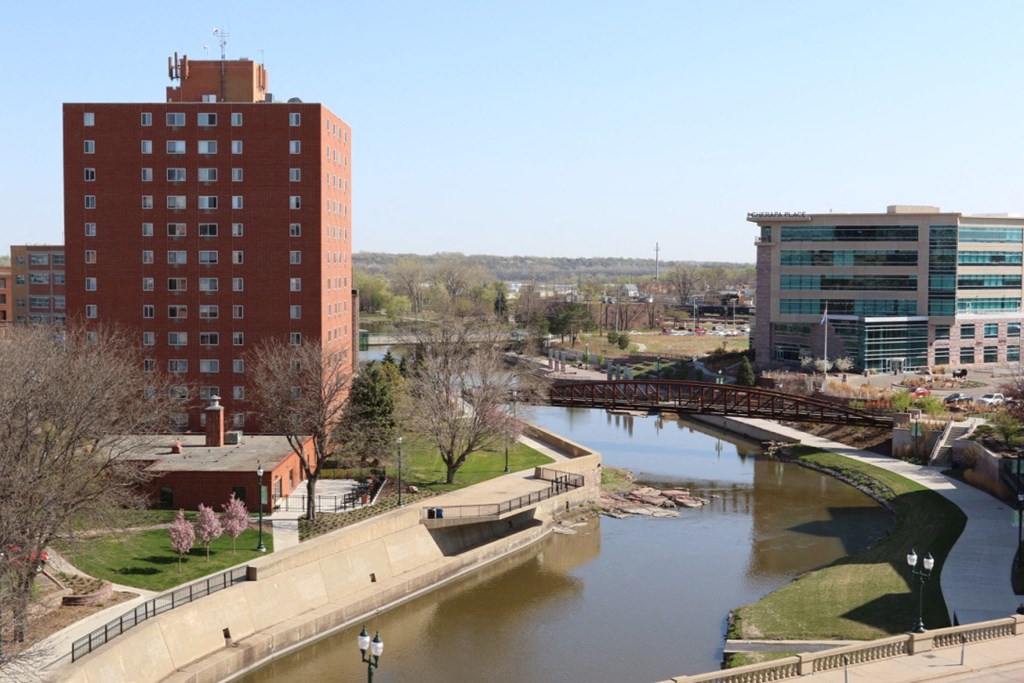 a river running through a city with buildings and a bridge