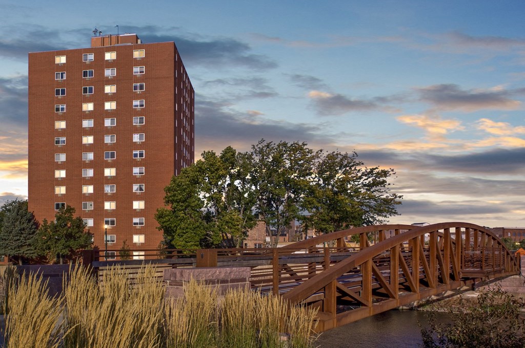 a bridge over a river with a building in the background