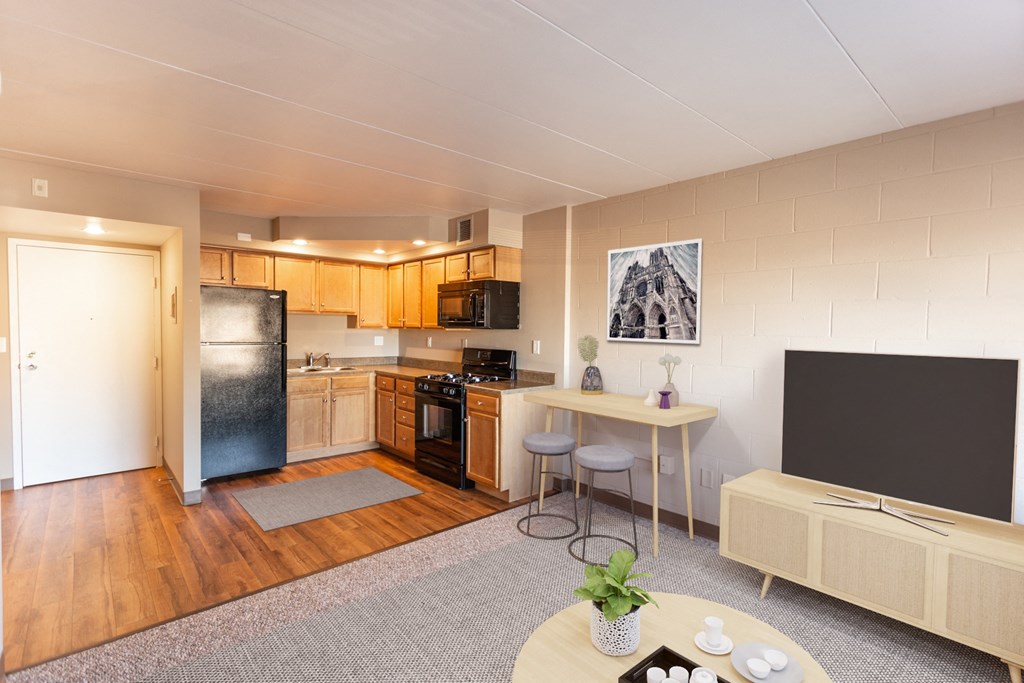 an open kitchen and living room with a table and a tv