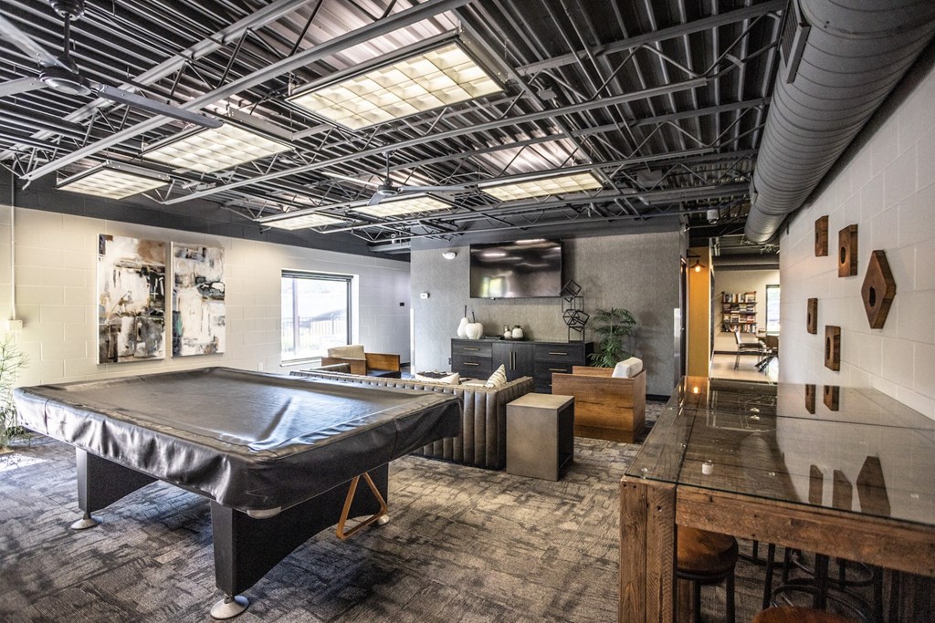 a living room with a pool table and other furniture
