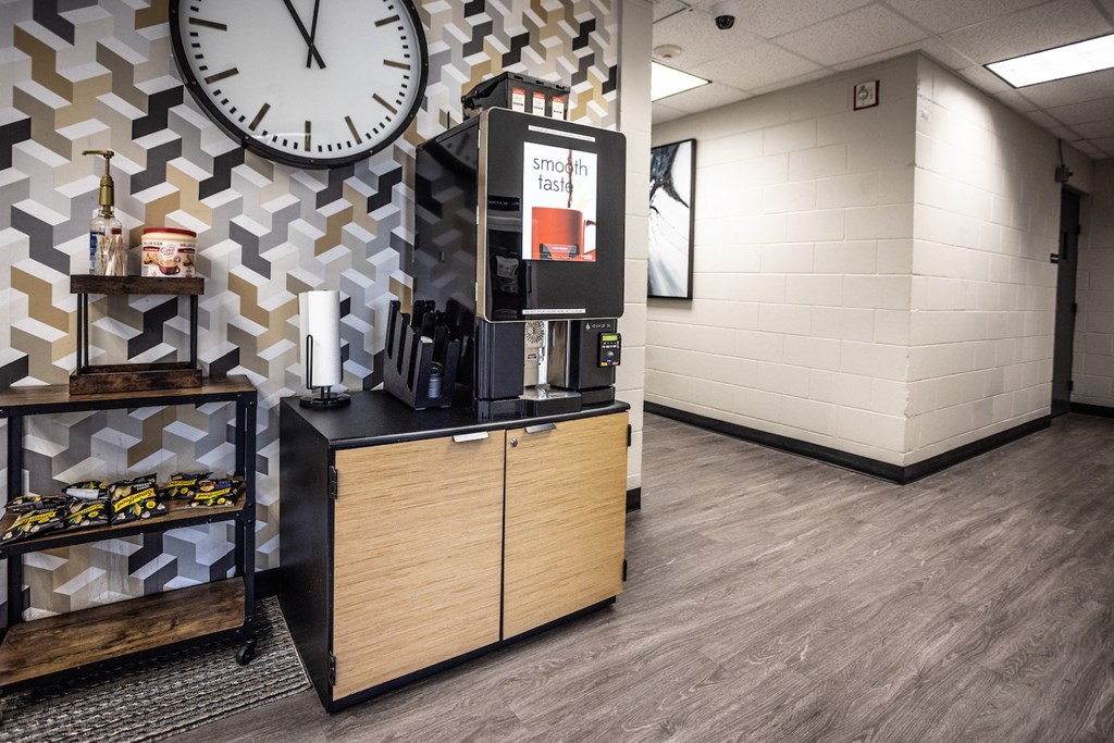the lobby of a coffee shop with a clock on the wall