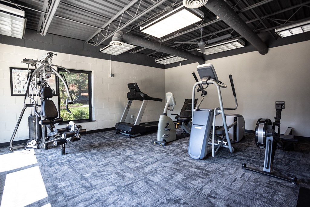 a gym with treadmills and other exercise equipment in a building
