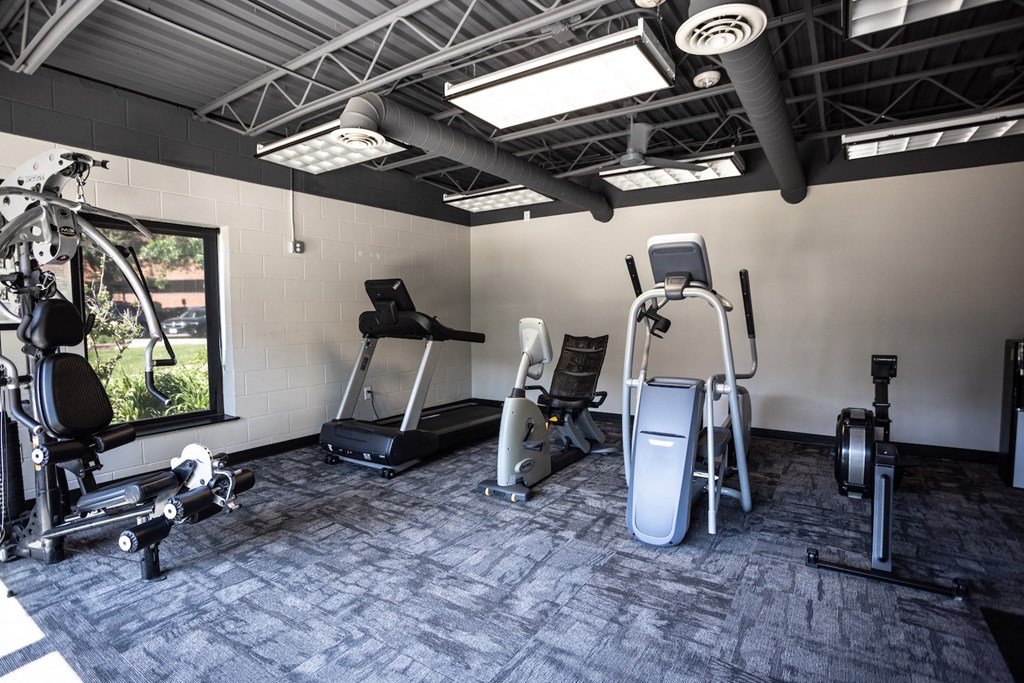 a gym with treadmills and other exercise equipment in a building