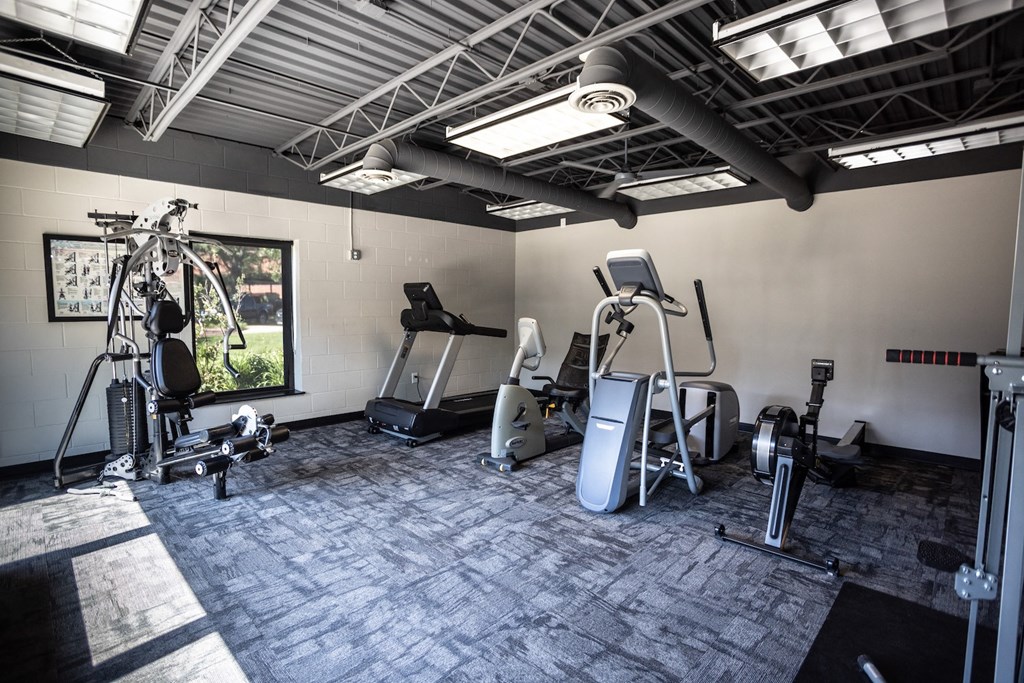 a gym with treadmills and other exercise equipment in a building