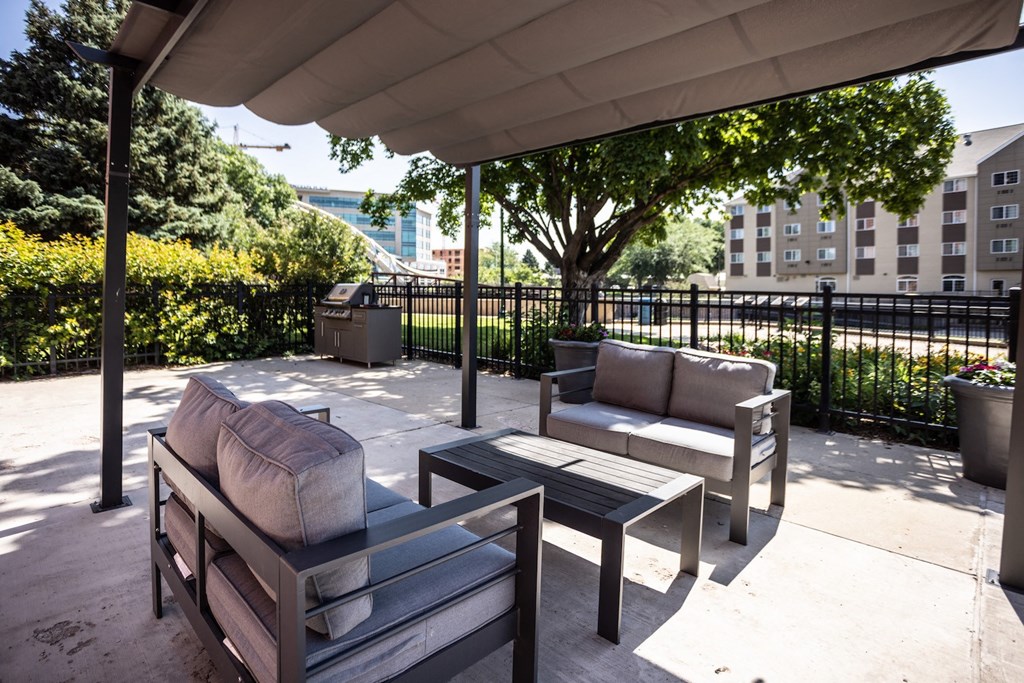 a patio with couches and chairs and a table
