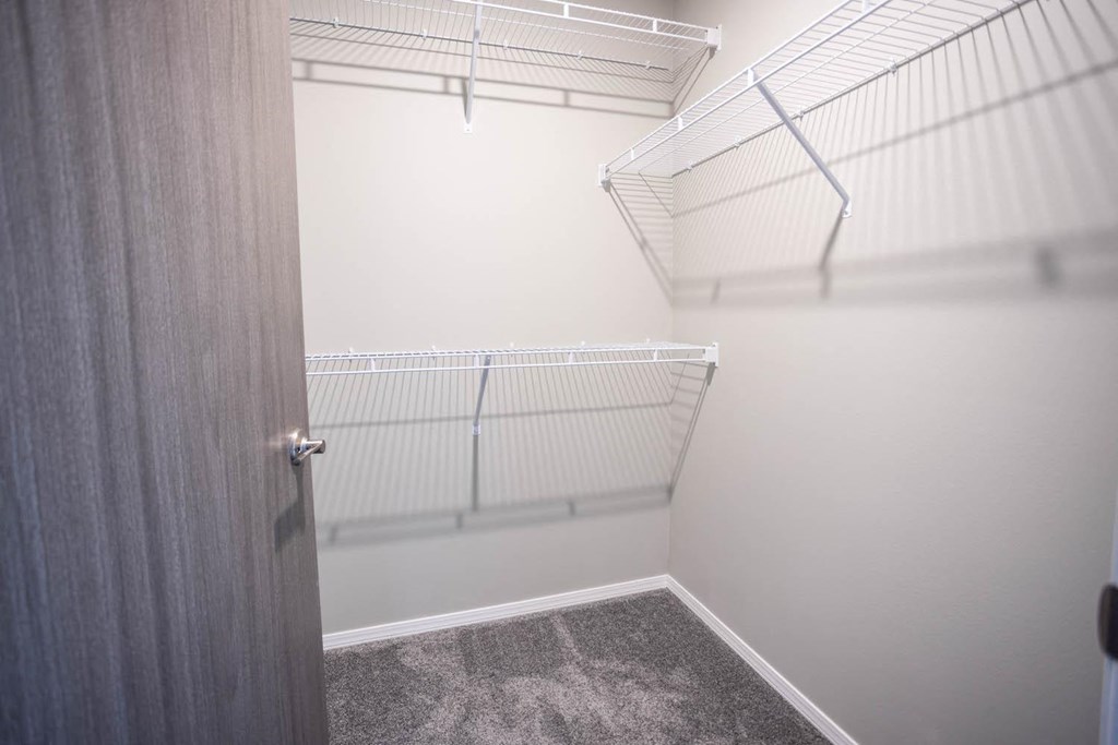 the walk in closet of a bedroom in a house