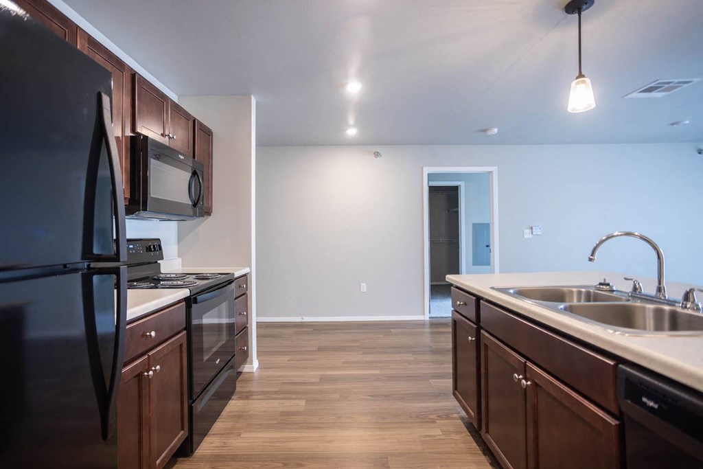 a kitchen with a sink and a refrigerator