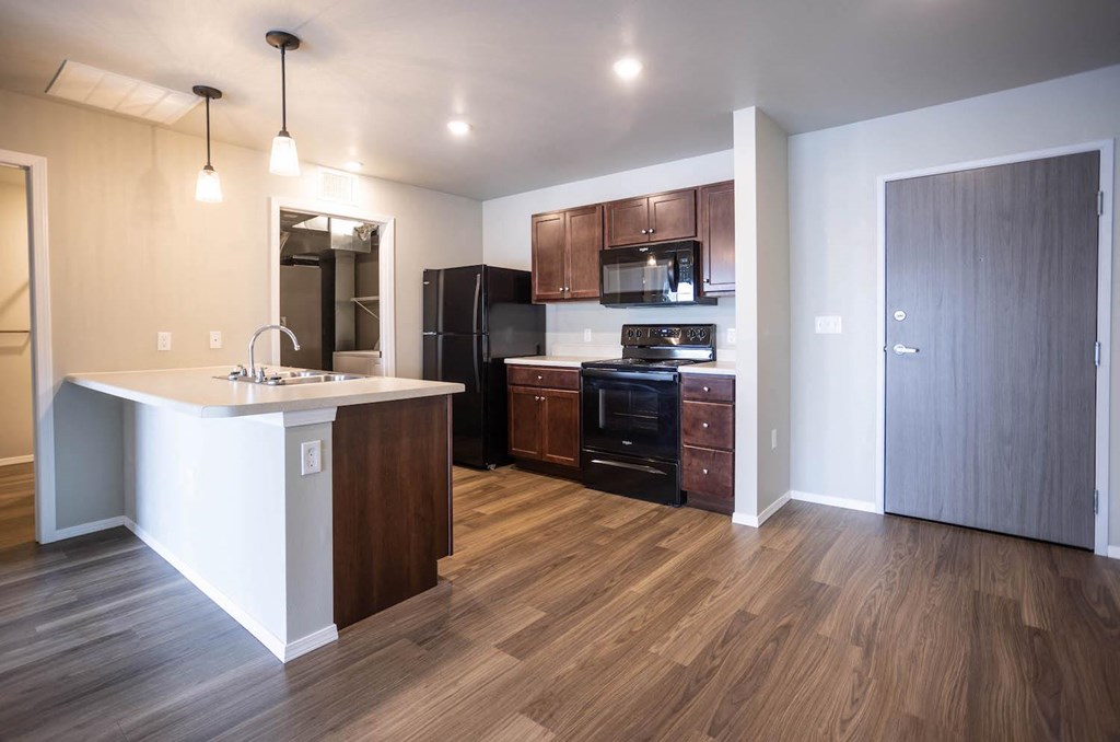 a kitchen with a sink and a refrigerator