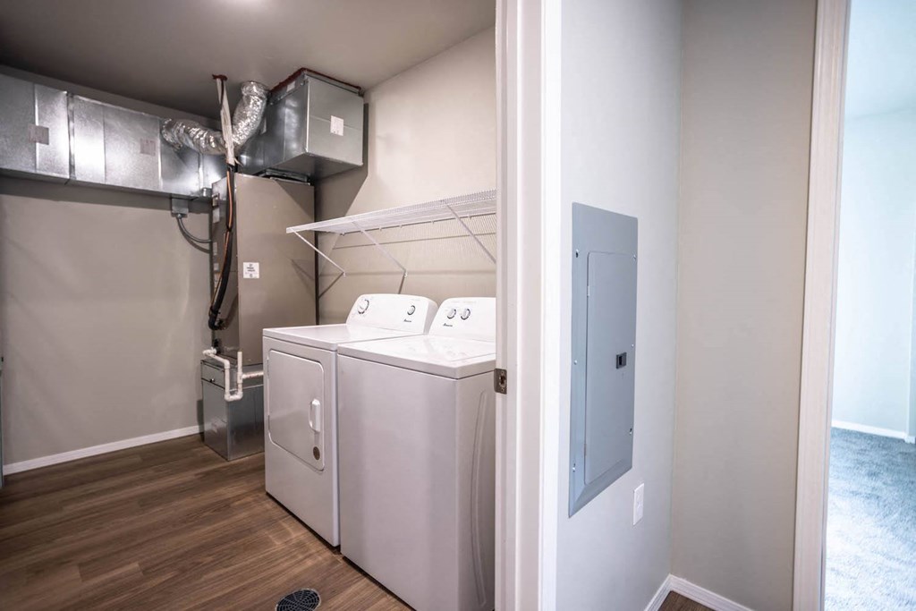 a laundry room with a washer and dryer and a closet