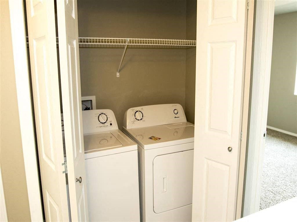 a washer and dryer in a room with a closet