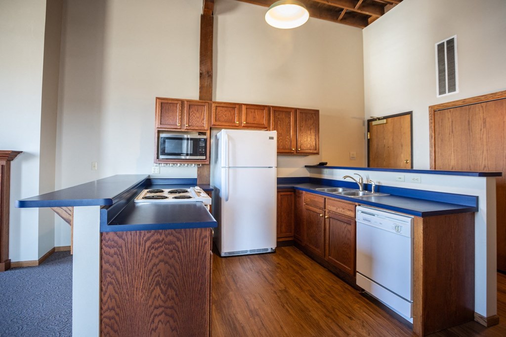 a kitchen with blue counter tops and a white refrigerator