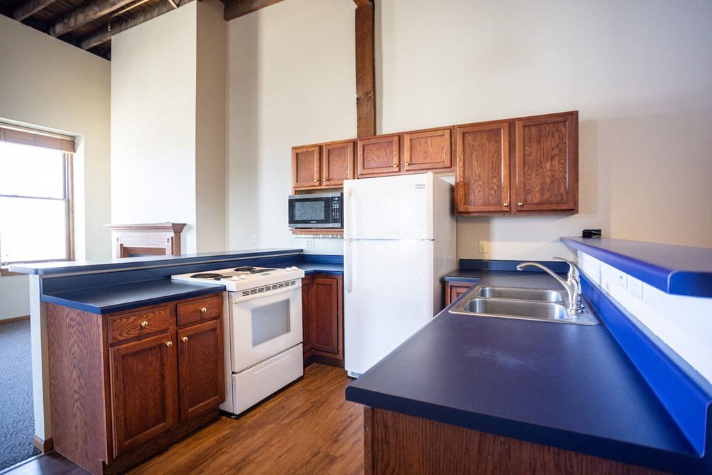 a kitchen with blue counter tops and white appliances