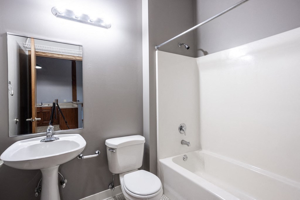 a bathroom with a sink toilet and a bath tub