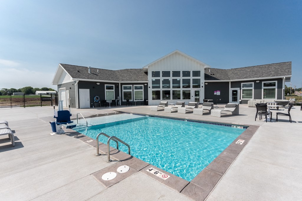 our apartments have a large pool and lounge chairs in front of our building