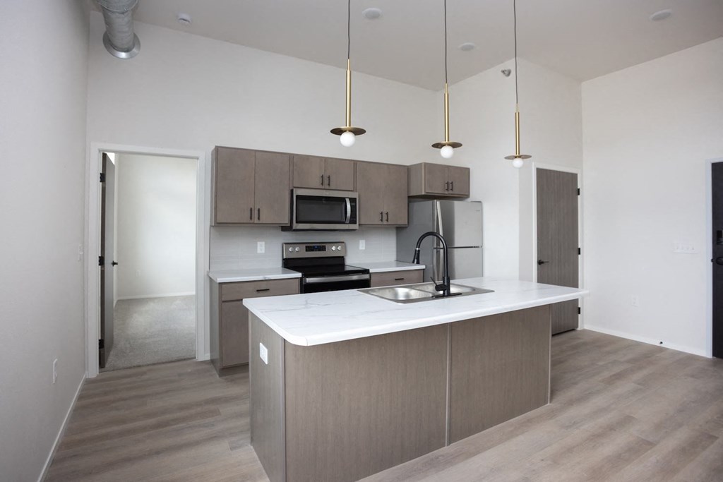 a kitchen with a white counter top and a sink